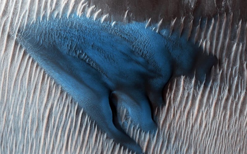 Mars is often dubbed the red planet, but footage from one of NASA's orbiters showed what appeared to be a striking blue sand dune. (NASA)