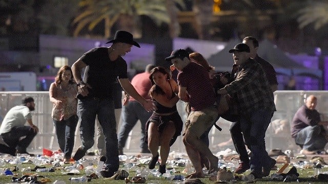 People carry a peson at the Route 91 Harvest country music festival after apparent gun fire was heard on October 1, 2017 in Las Vegas, Nevada. There are reports of an active shooter around the Mandalay Bay Resort and Casino. (Photo by David Becker/Getty)