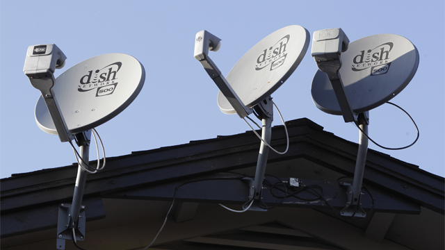 In this Feb. 23, 2011 file photo, three Dish Network satellite dishes, are displayed on an apartment house, in Palo Alto, Calif. (AP Photo/Paul Sakuma, File)